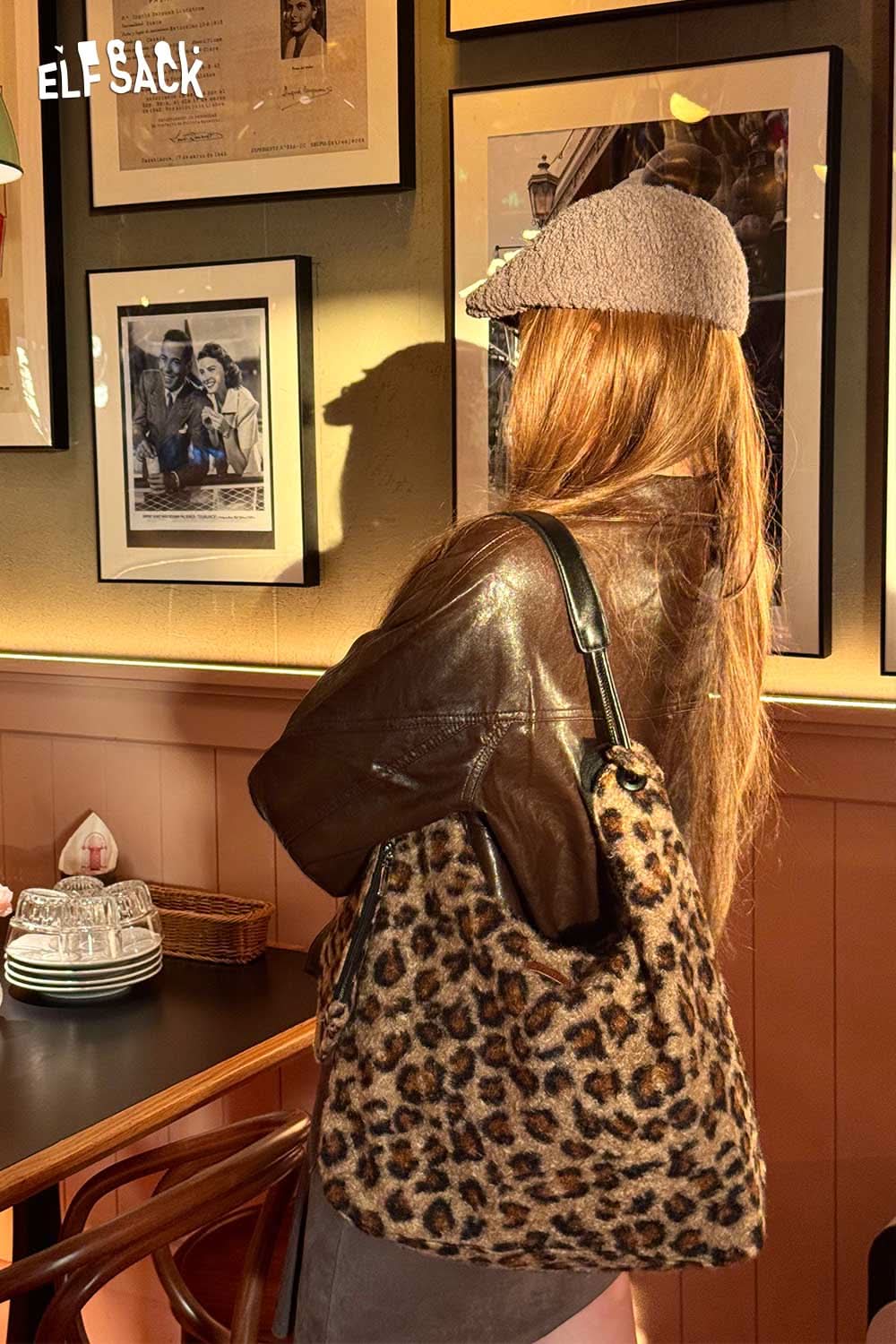 ELFSACK leopard print tote bag stylishly carried by a woman in a cozy cafe setting