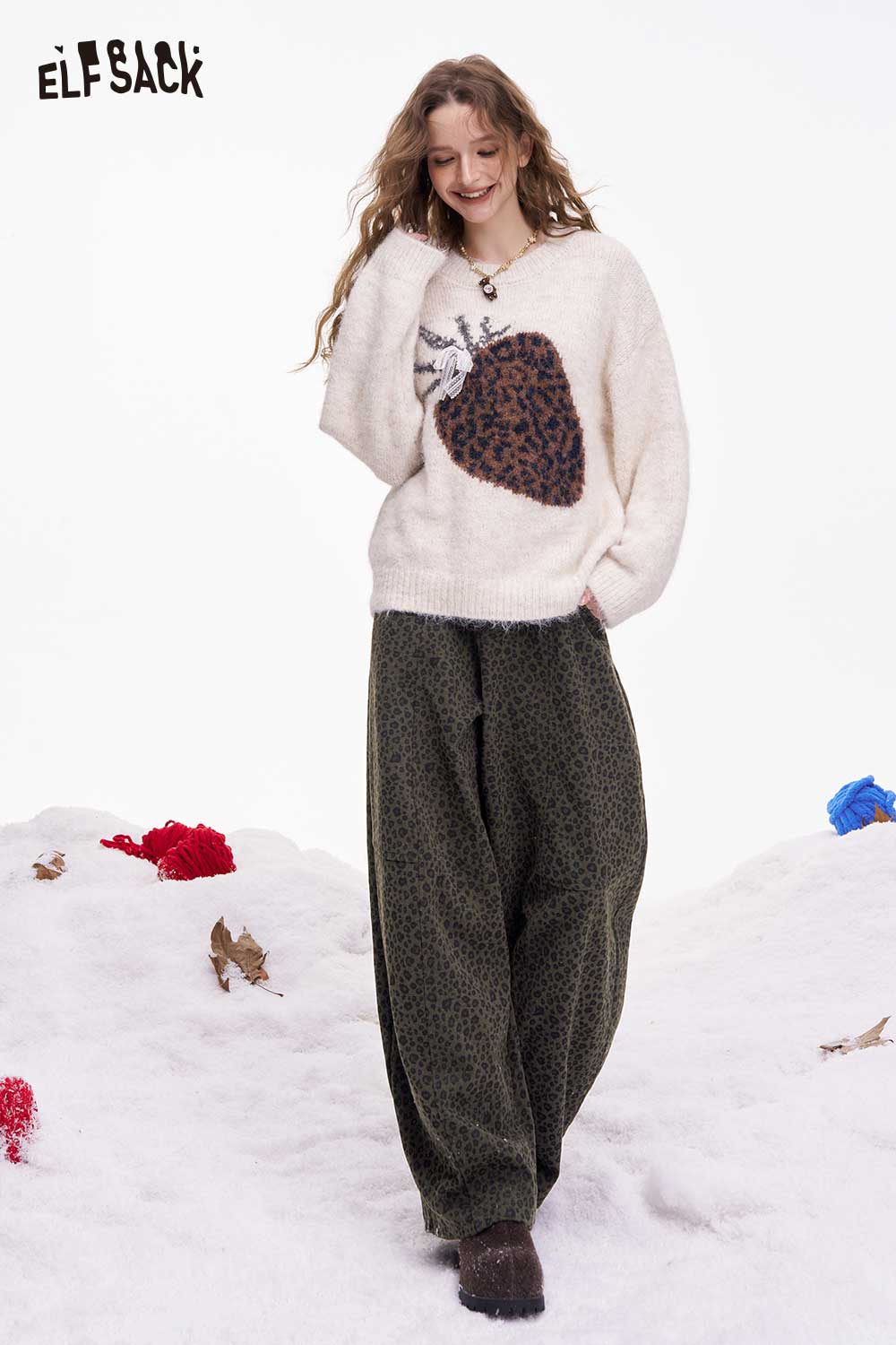 ELFSACK leopard print wide leg pants paired with a cozy sweater in a winter setting
