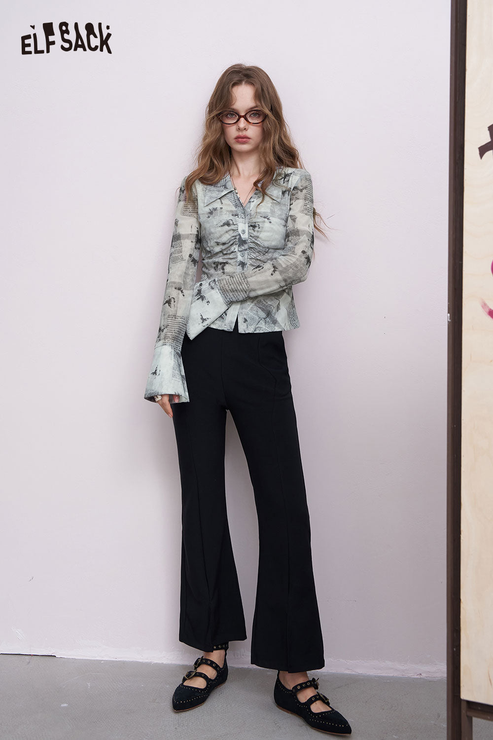 ELFSACK women's graphic pleated shirt in muted green abstract print worn by model with black flared pants