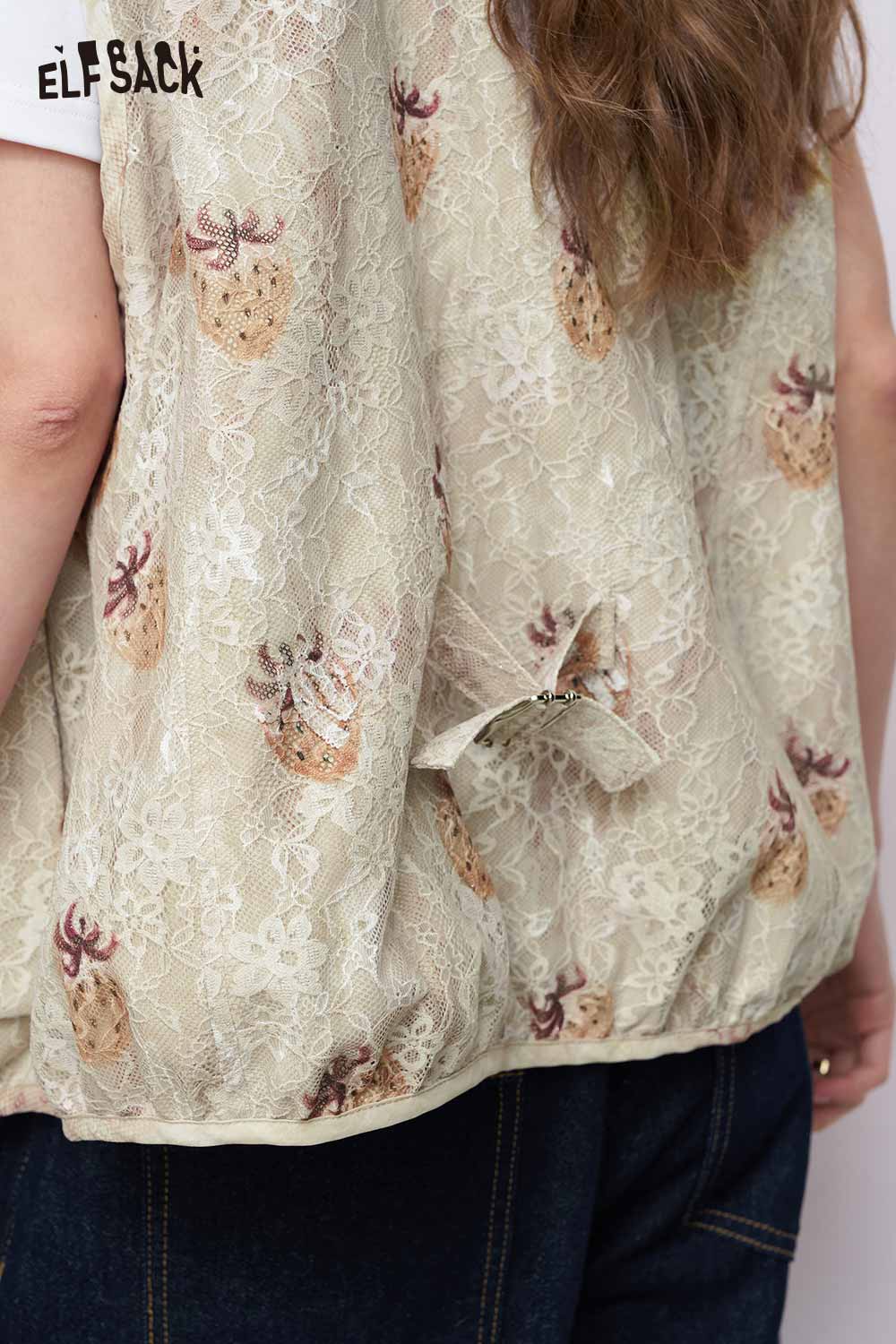 ELFSACK women's graphic lace vest in cream with pineapple print back bow and elastic hem over denim