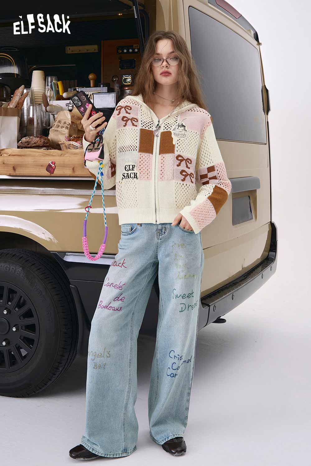 ELFSACK model wearing women's openwork knit zip hoodie cream patchwork with wide leg embroidered jeans