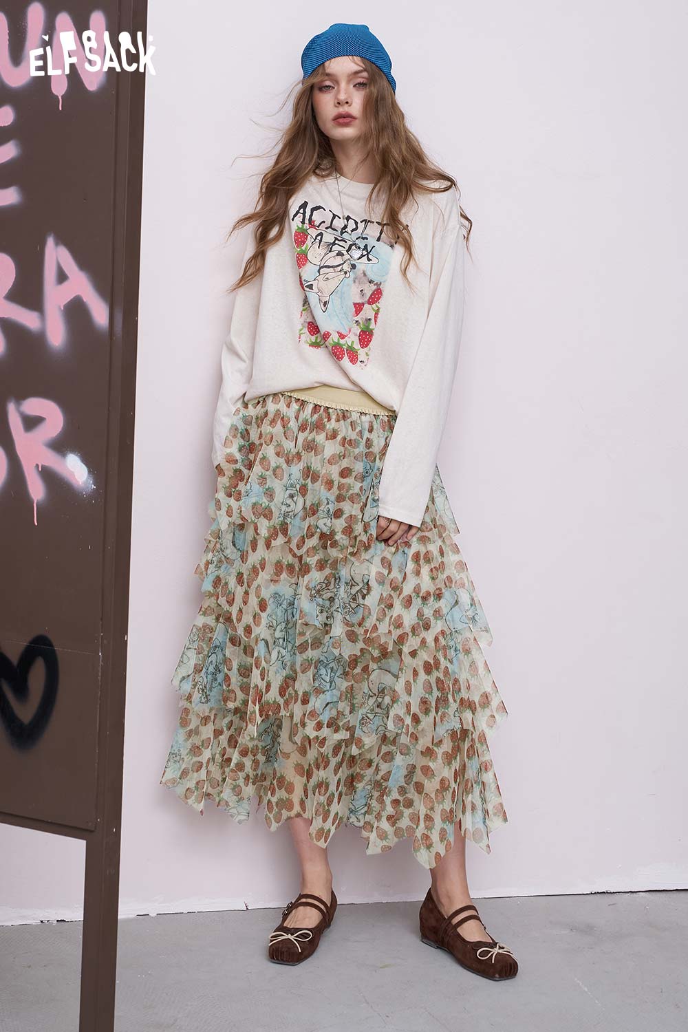 ELFSACK model wearing a tiered ruffle strawberry print chiffon skirt midi in mint and tan with layered tiers