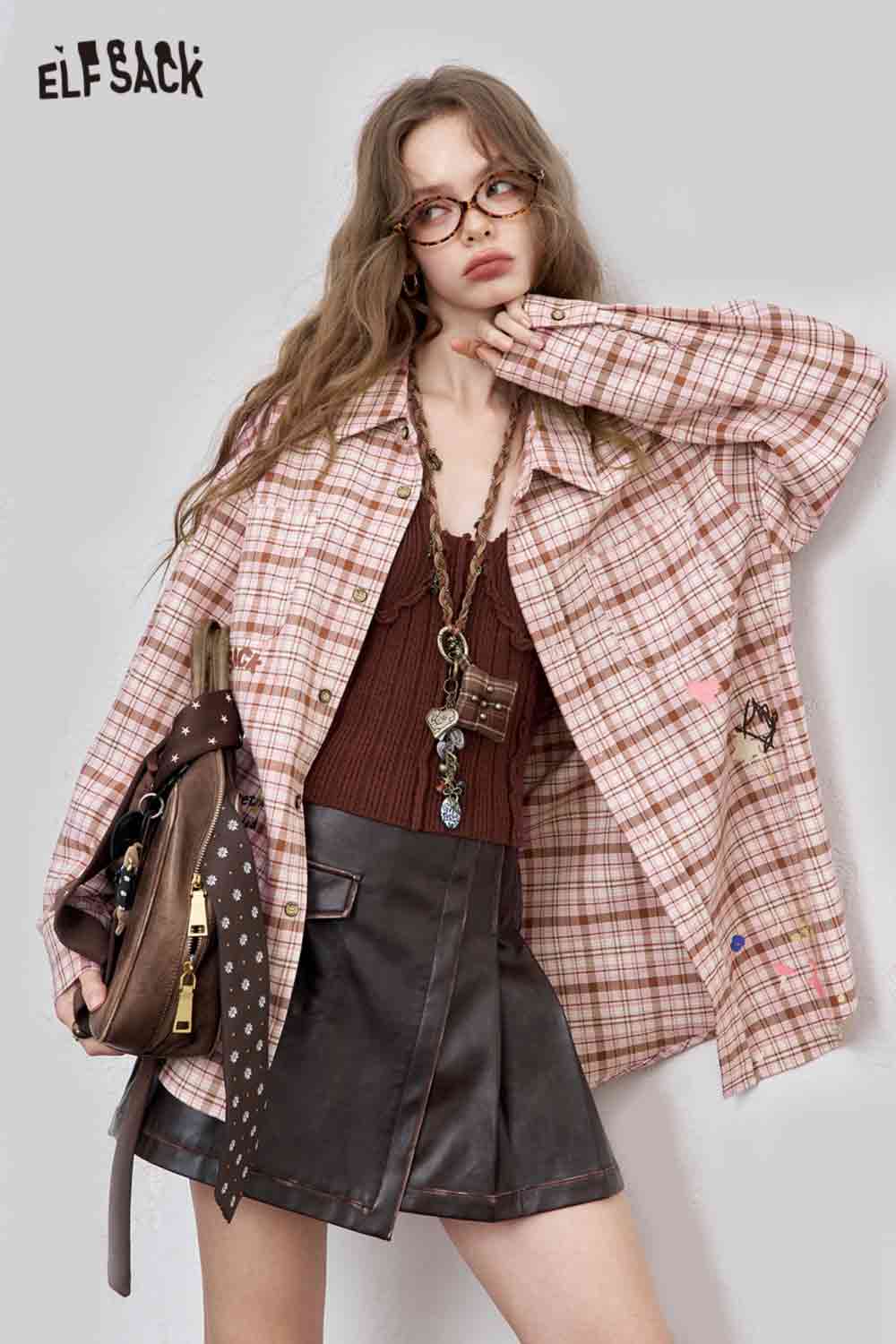 ELFSACK model wearing oversized pink college style plaid shirt for women layered over brown knit top