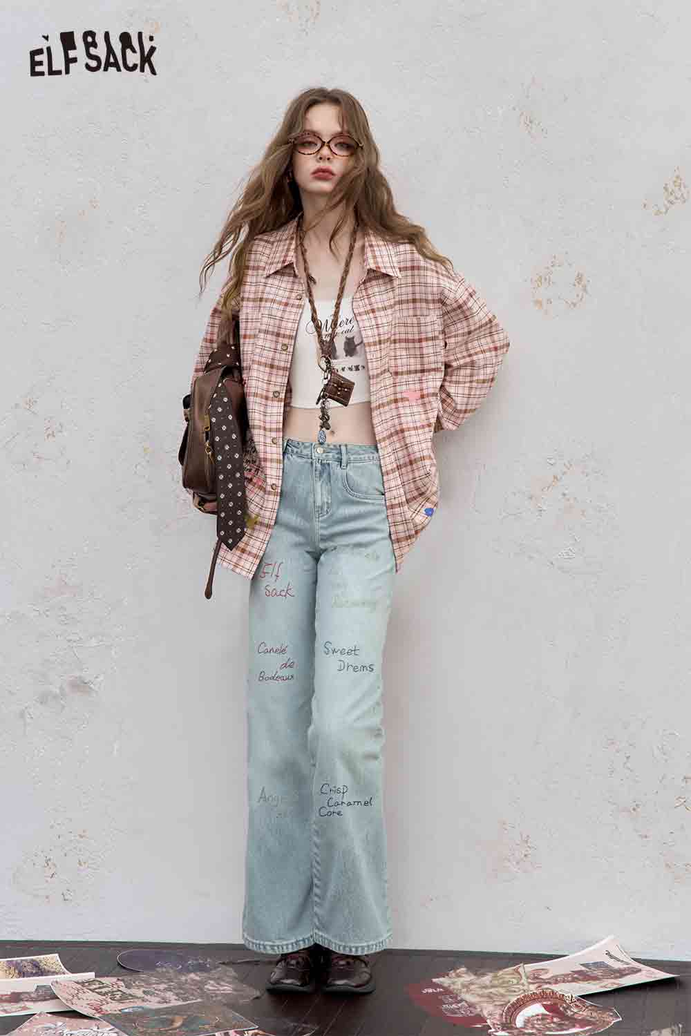 ELFSACK model wearing college style plaid shirt for women oversize pink plaid shirt with crop top and light wash embroidered jeans