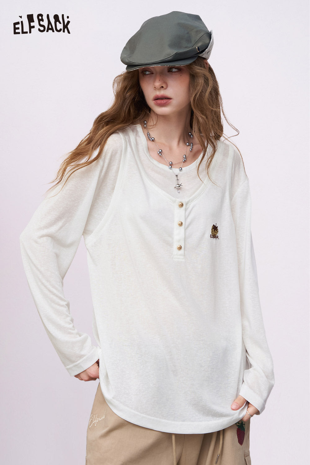 ELFSACK relaxed long sleeve cream henley with small embroidered chest motif linen blend embroidery tee for women