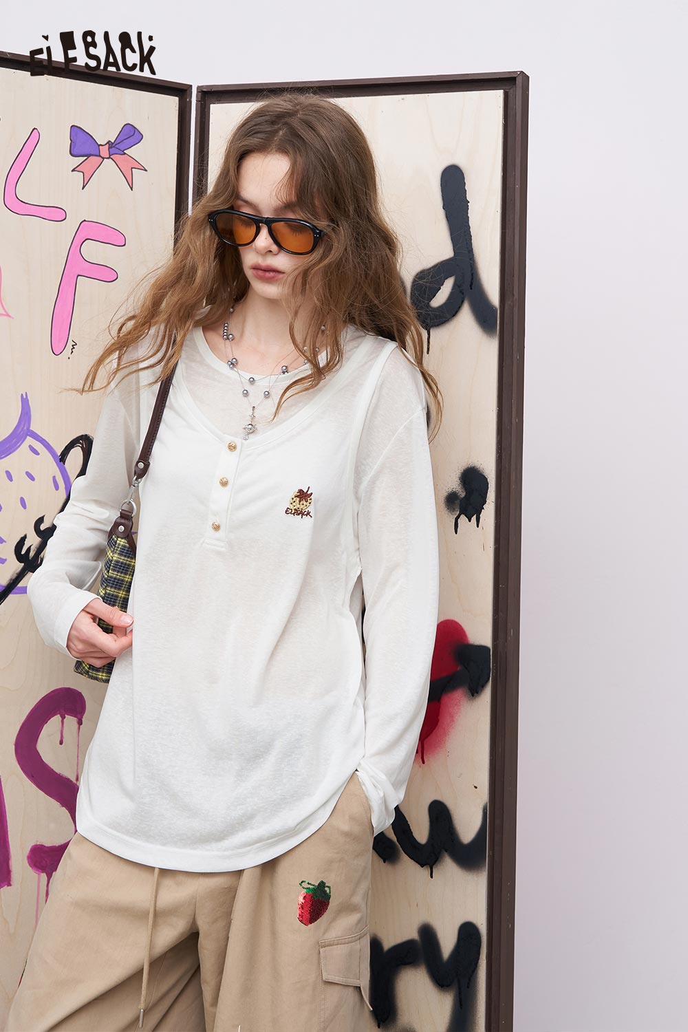 ELFSACK model wearing linen blend embroidery tee for women white long sleeve henley with chest embroidery