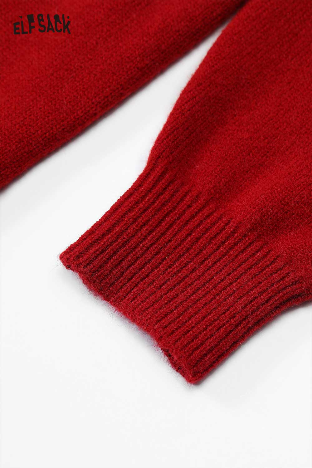 Close-up of the sleeve cuff detail on a red loose knit dress for women by ELFSACK
