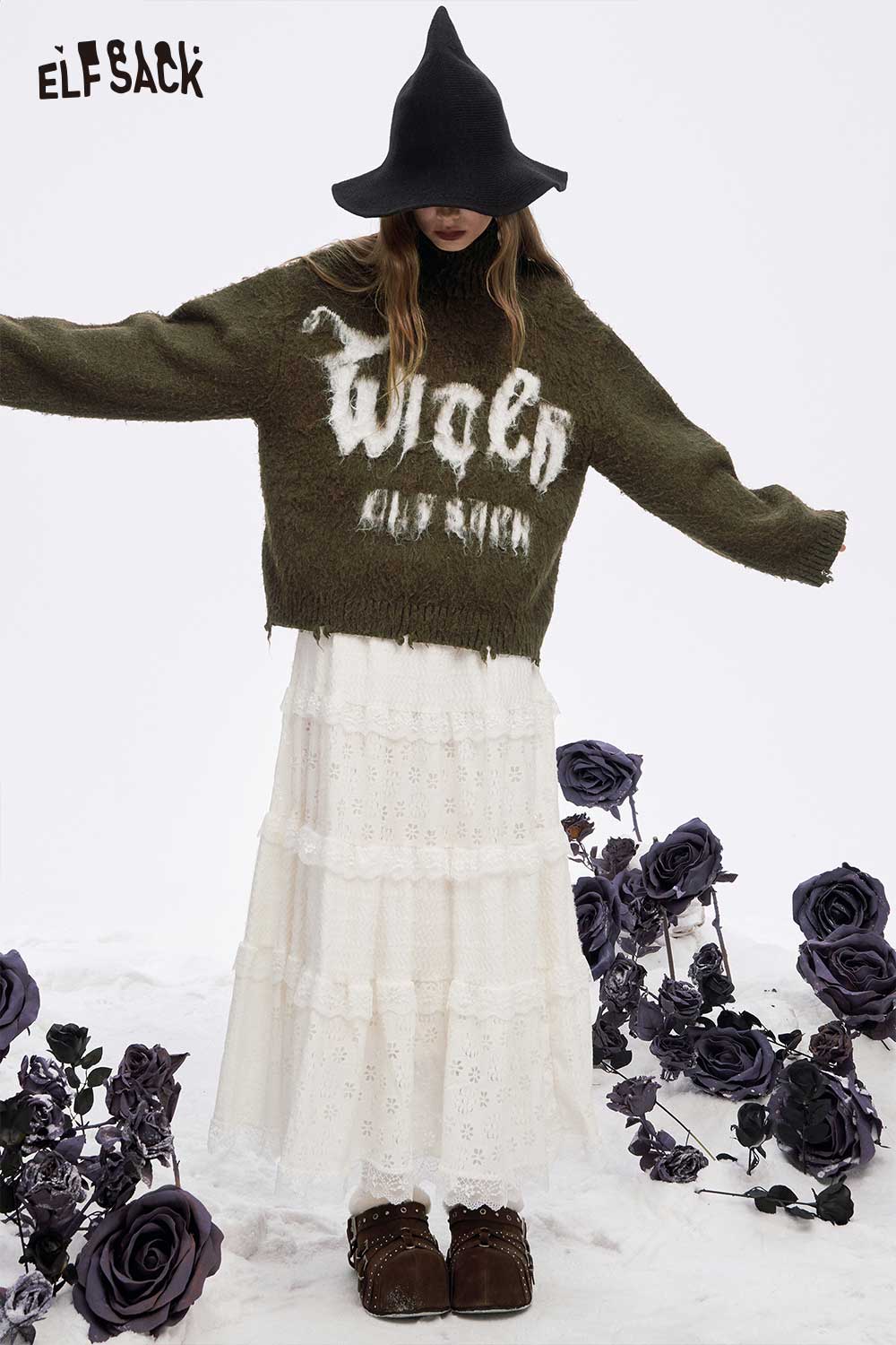 Loose letter graphic fringe sweater by ELFSACK, styled with a white tiered skirt and floral accents