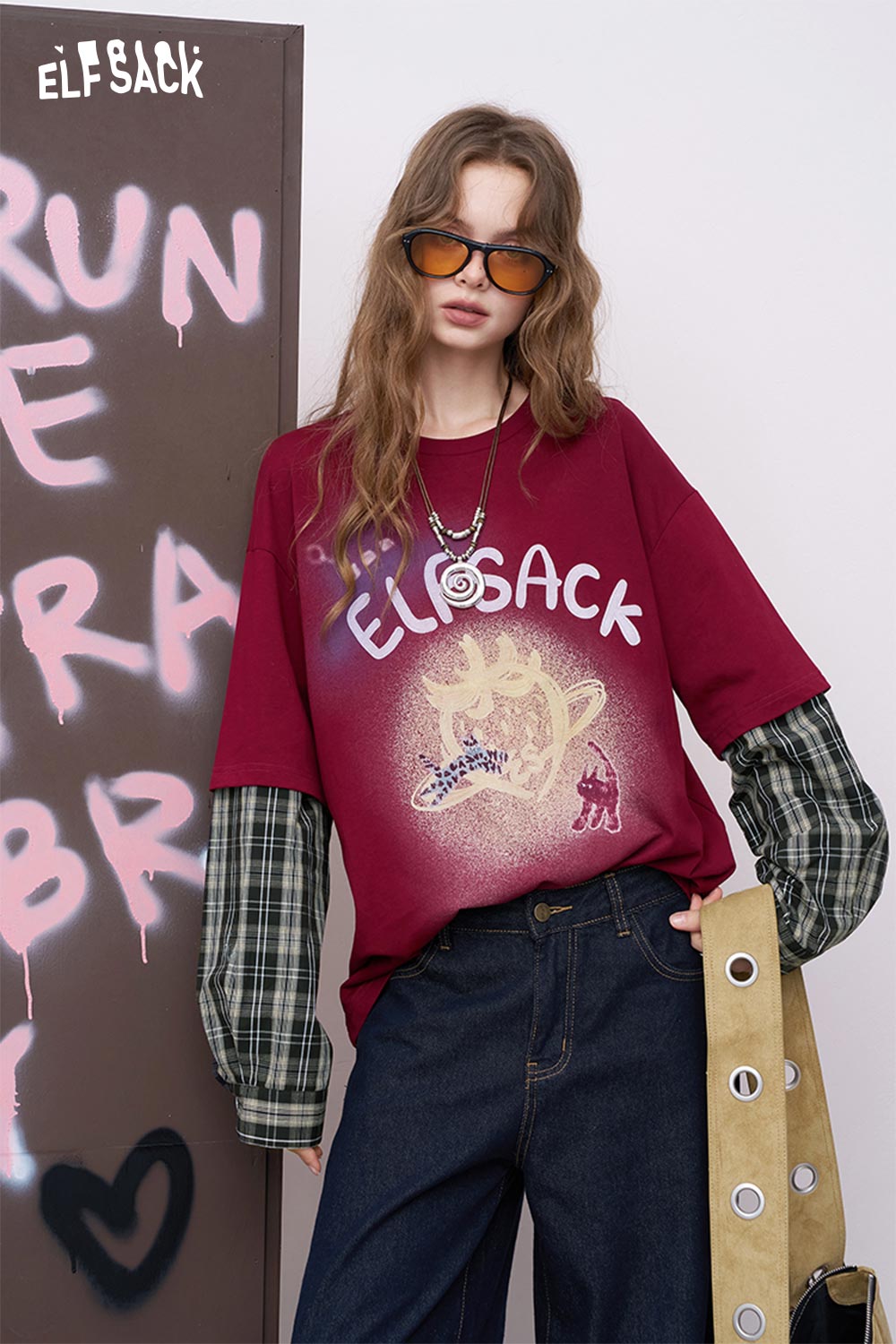 ELFSACK model wearing luminous strawberry embroidered tee burgundy oversized print layered with plaid sleeves