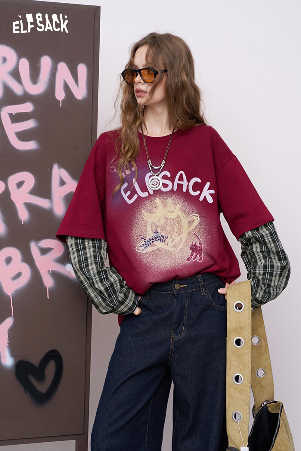 ELFSACK maroon luminous strawberry embroidered tee worn with layered plaid sleeves and high waist jeans