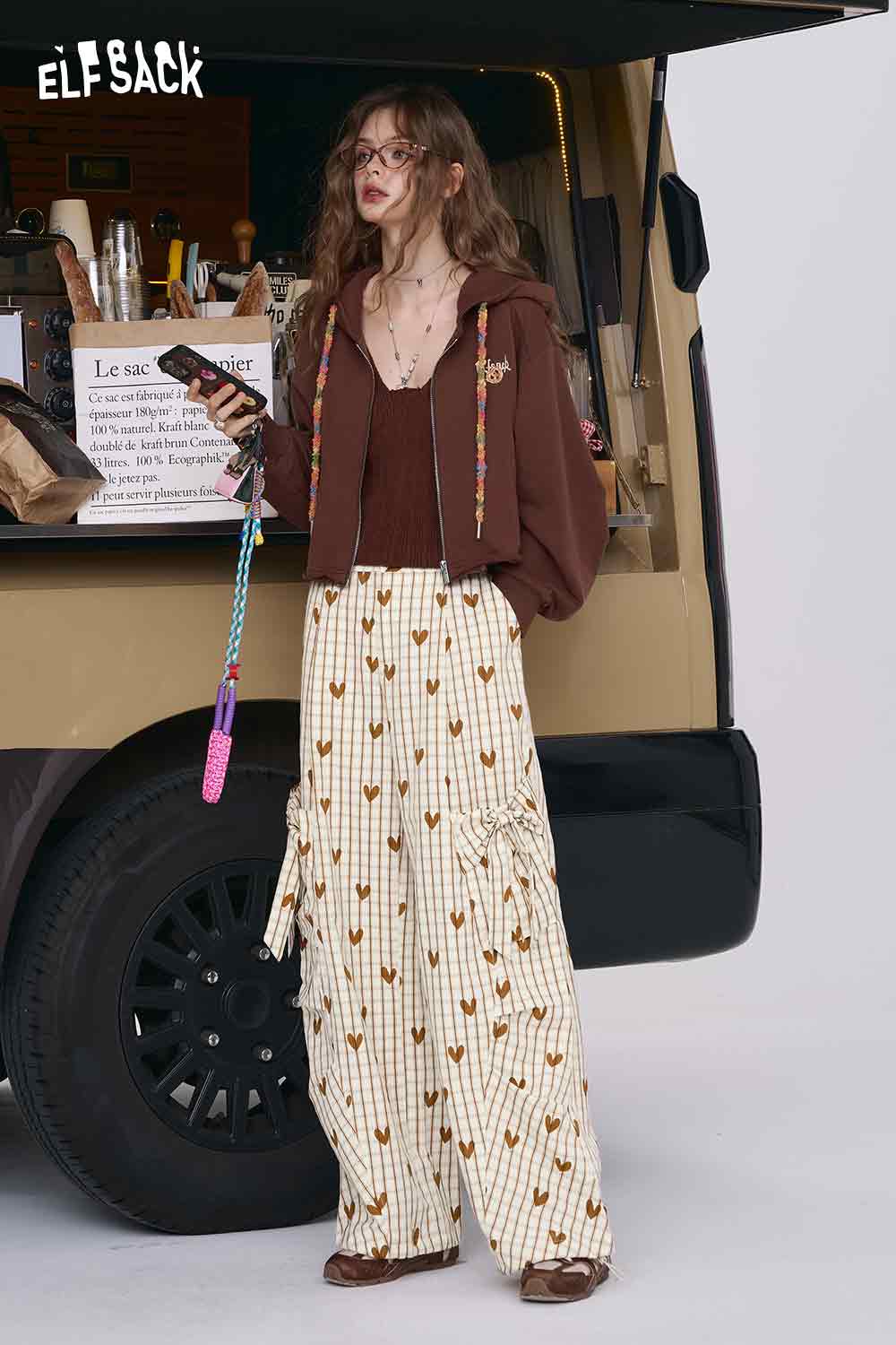 ELFSACK heart plaid wide-leg pants in cream with brown heart print and ruffle tiers worn with brown cardigan