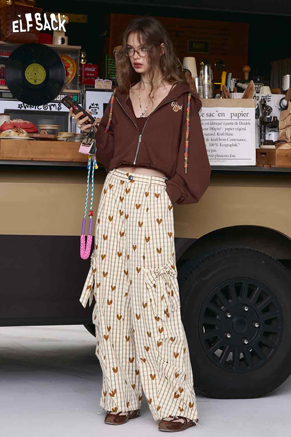 ELFSACK model wearing heart plaid wide-leg pants in cream with brown heart print high waist flowy silhouette