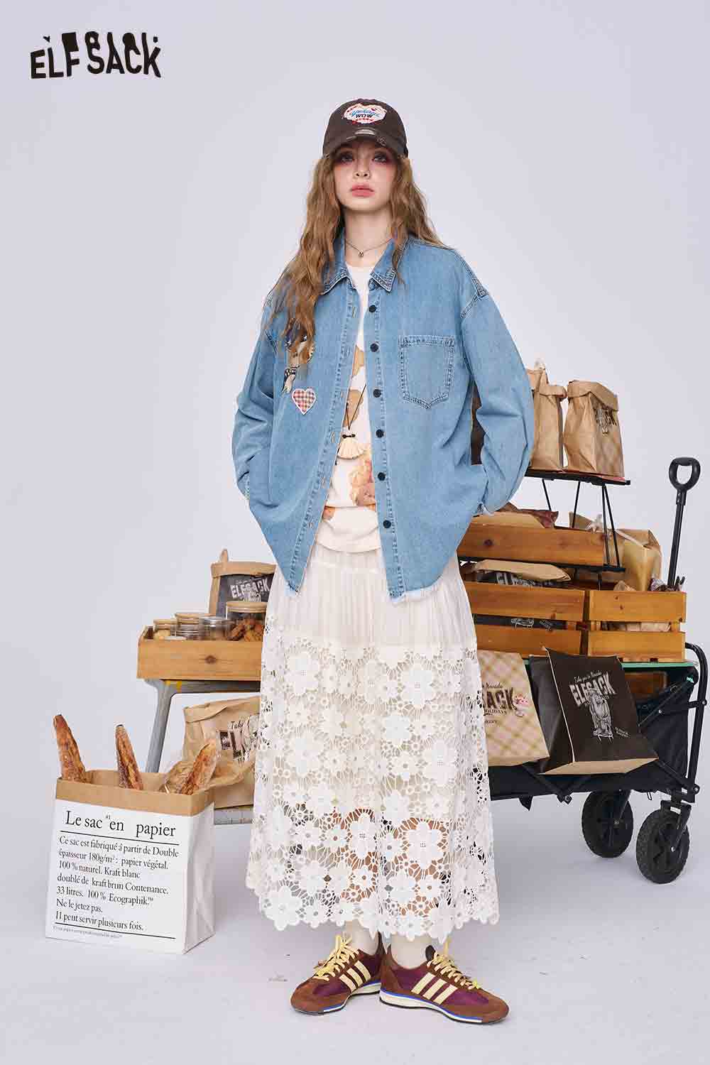 ELFSACK model wearing 3D mushroom denim shirt for women styled oversized with lace maxi skirt and sneakers