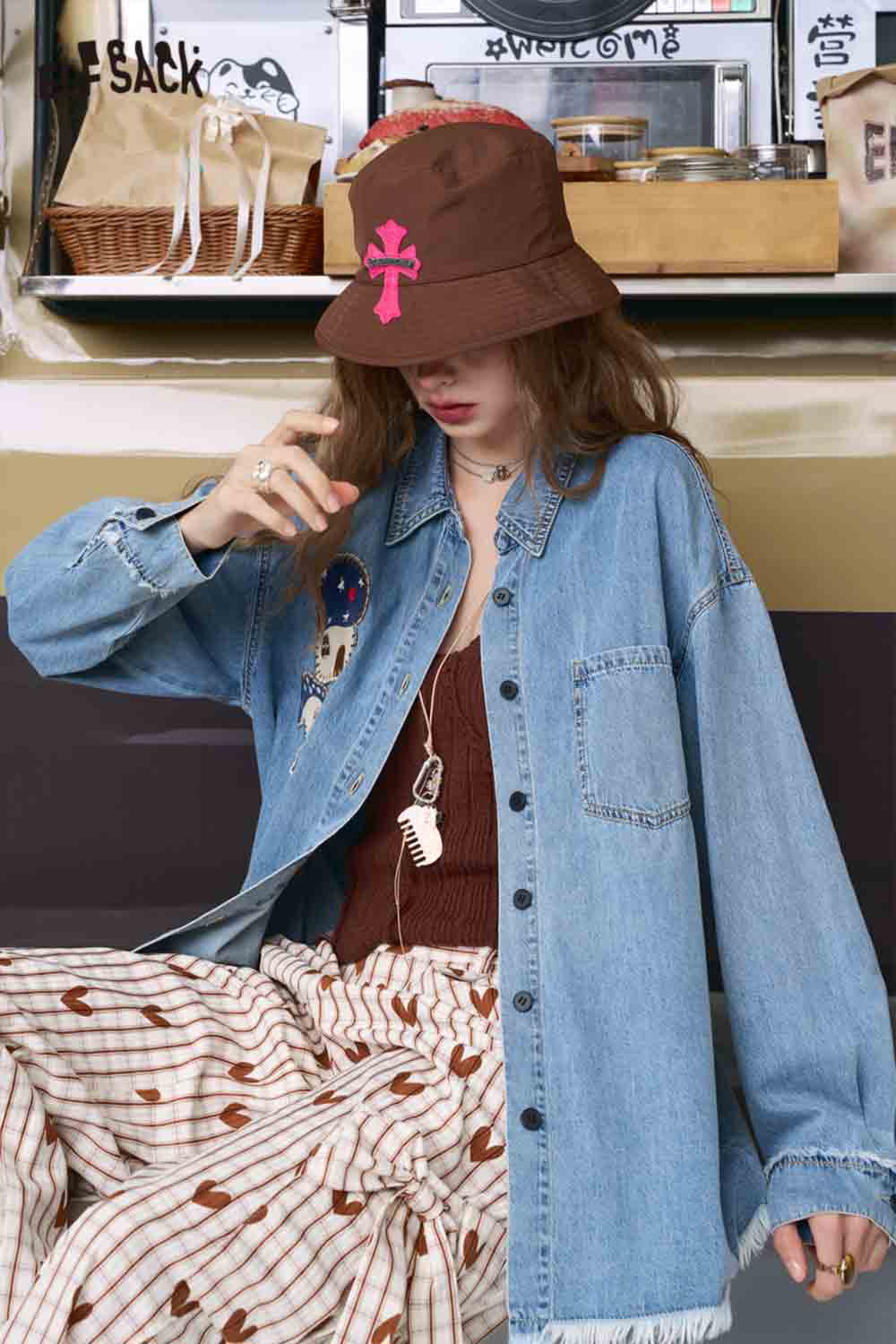 ELFSACK oversized light wash 3D mushroom denim shirt for women. styled with brown hat and striped skirt