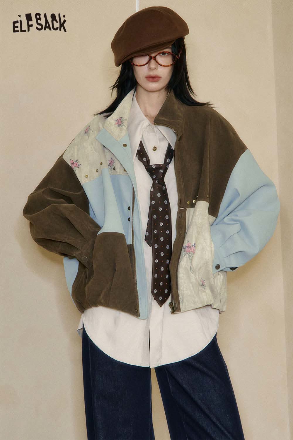 ELFSACK patchwork jacket layered over a white shirt and tie, styled with a lyocell blend semi-sheer knit top