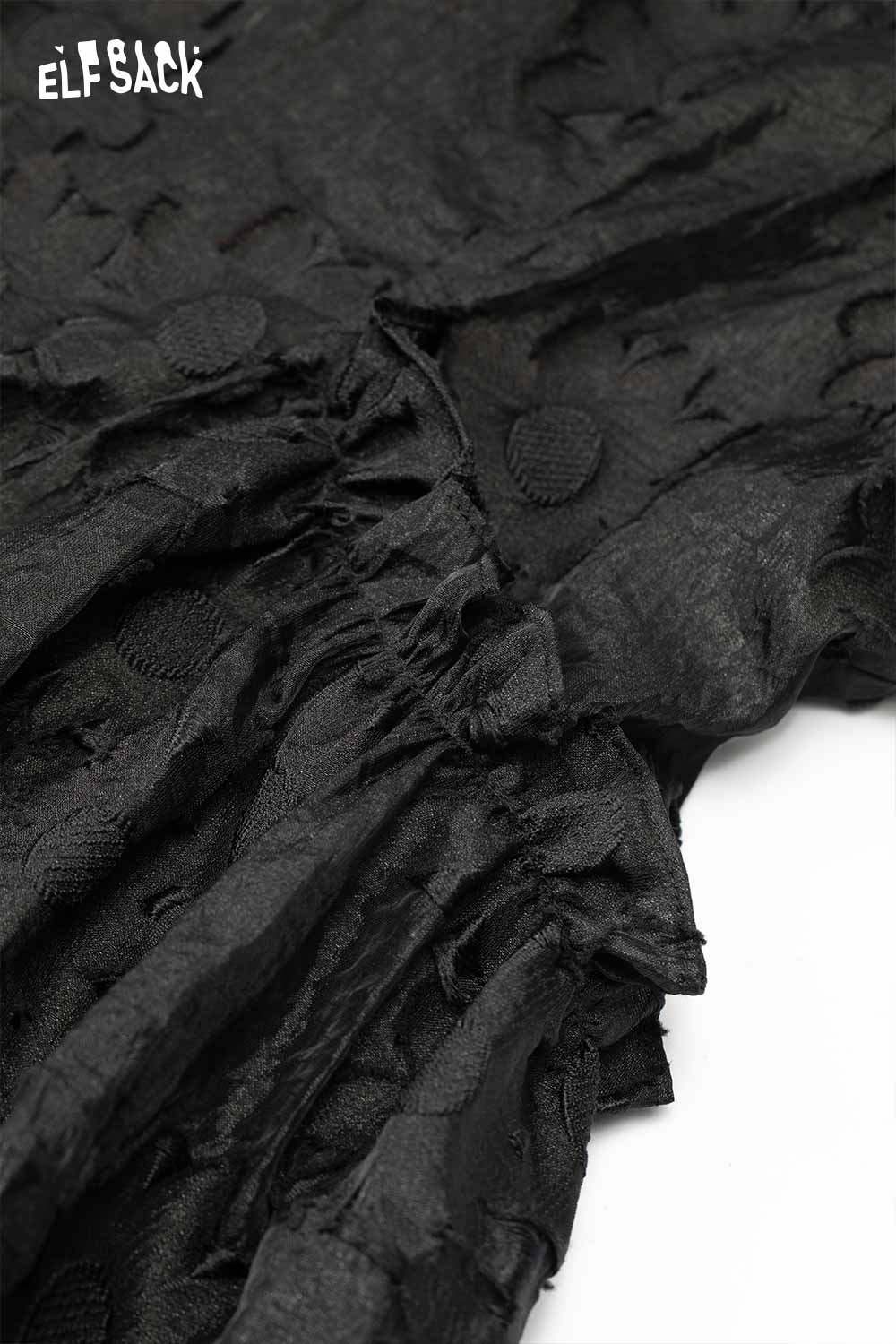 Close-up of ELFSACK mandarin collar embroidered dress showcasing unique textured fabric details