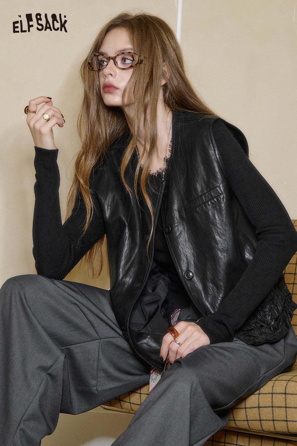 ELFSACK matte black PU leather sleeveless top styled with a casual outfit for trendy looks