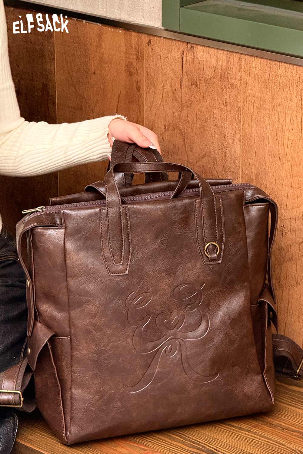 Stylish minimalist brown backpack for women with embossed detailing and adjustable straps