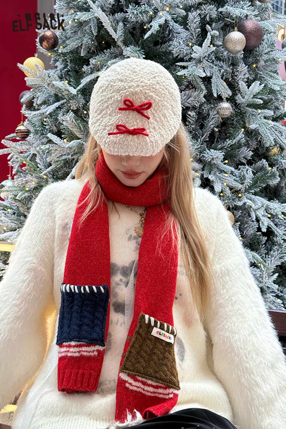 ELFSACK minimalist color block scarf for women styled with a cozy sweater and cap in festive setting