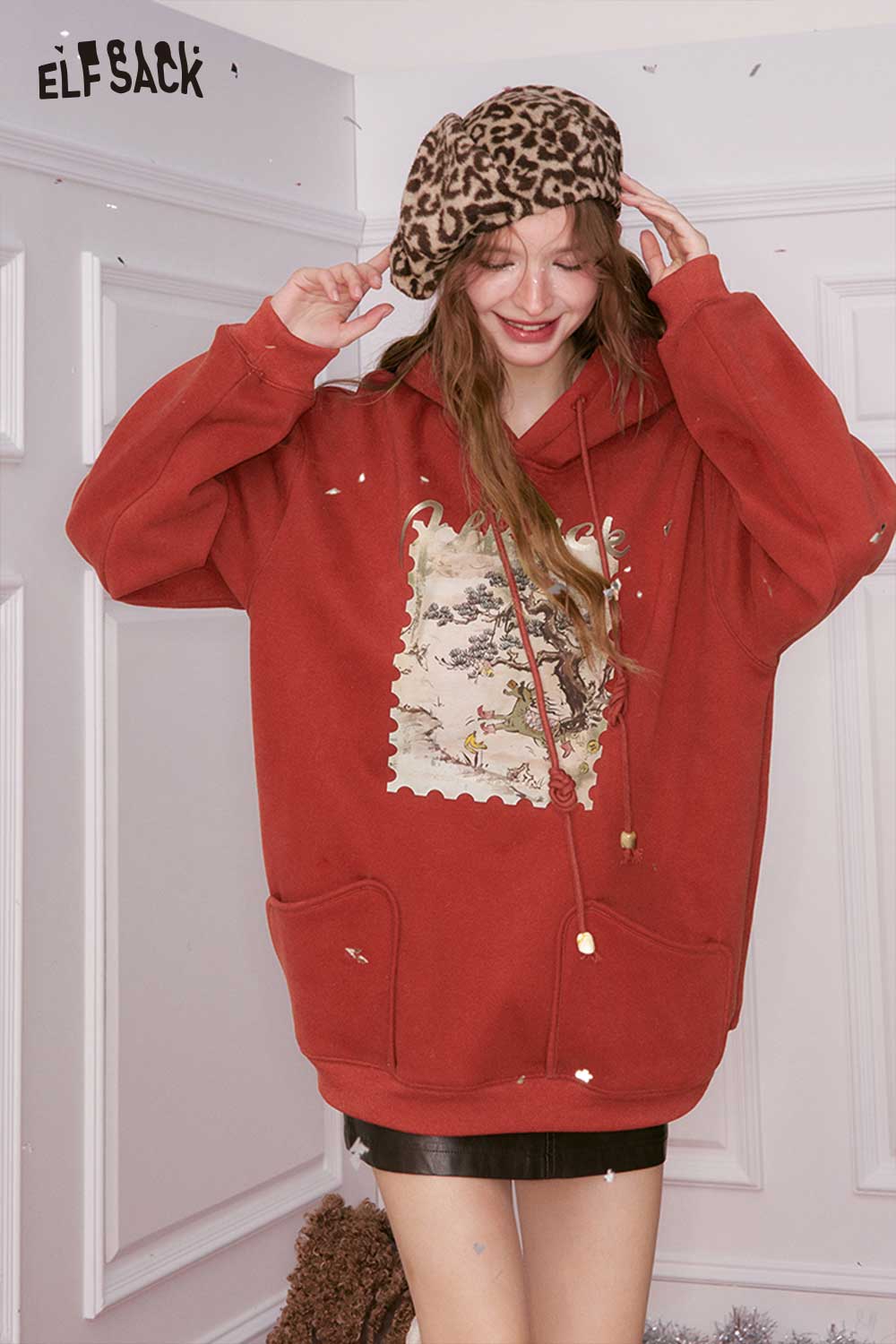 Cozy ELFSACK minimalist graphic hooded sweatshirt in red with a playful design and front pockets