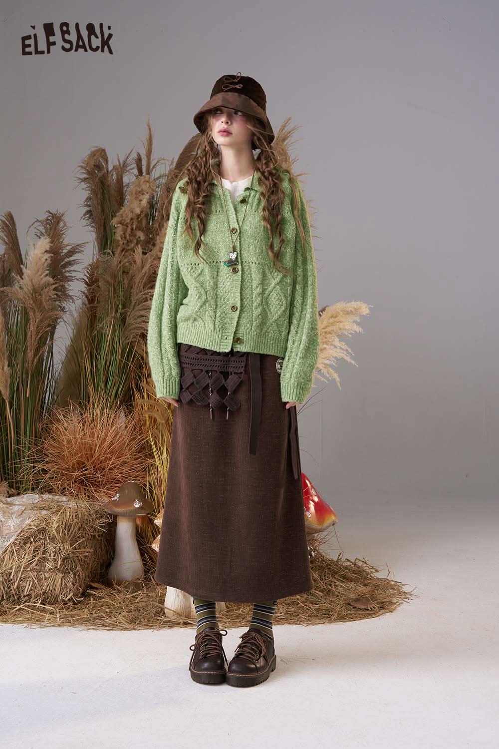 ELFSACK minimalist knit cardigan for women in green paired with a brown skirt and stylish accessories
