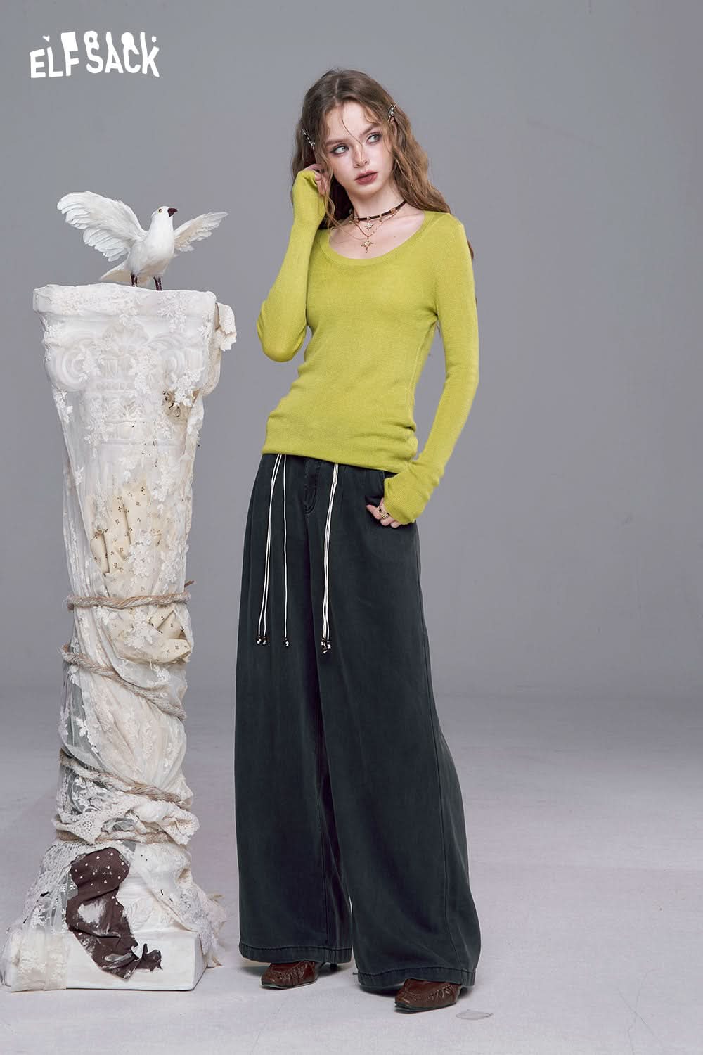 ELFSACK minimalist knit pullover for women in green paired with wide-leg black pants