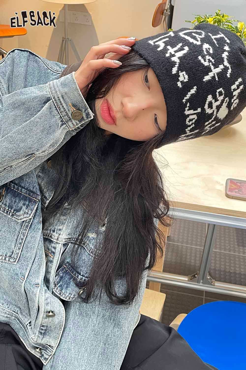 ELFSACK minimalist letter graphic beanie in black and white worn by a girl with long dark hair