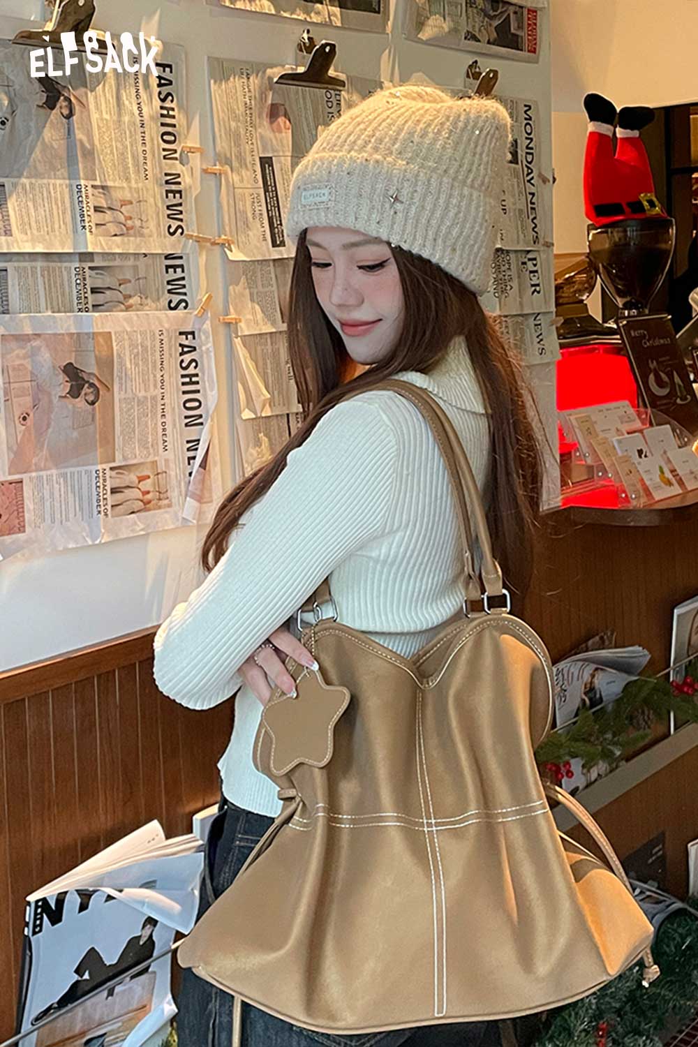 ELFSACK minimalist PU leather shoulder bag in tan color, styled with a cozy sweater and winter hat