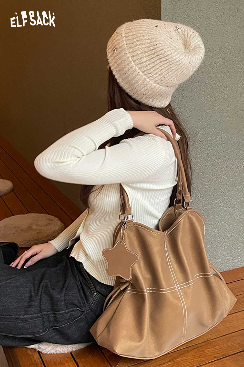 ELFSACK minimalist PU leather shoulder bag worn casually by a woman in a cozy outfit