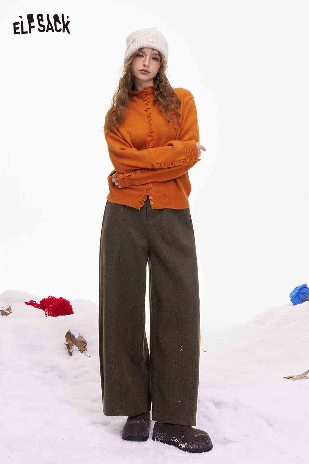 ELFSACK minimalist wide leg pants women in olive green paired with an orange sweater and winter hat