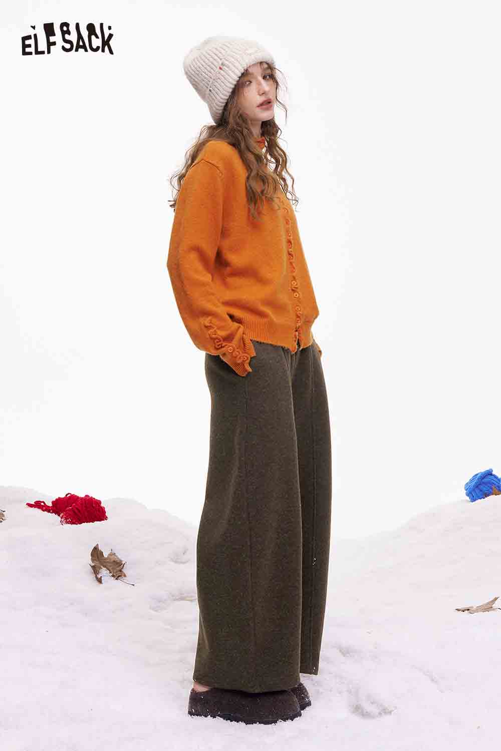 ELFSACK minimalist wide leg pants women in olive green, paired with an orange sweater and winter beanie