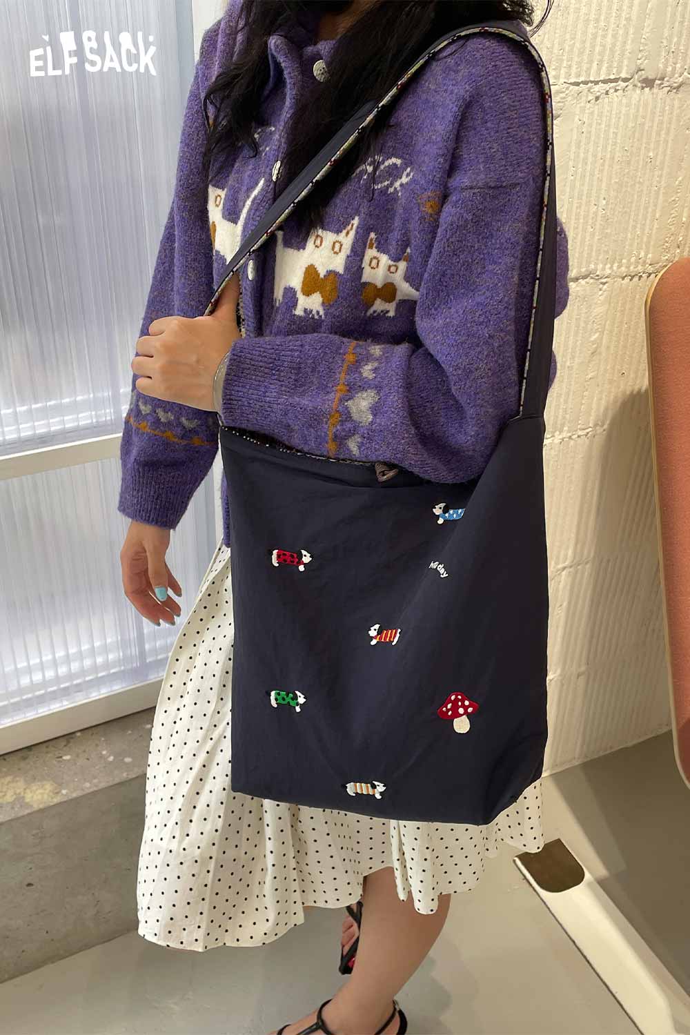 ELFSACK multi color checkered shoulder bag worn casually with a knitted sweater and polka dot dress