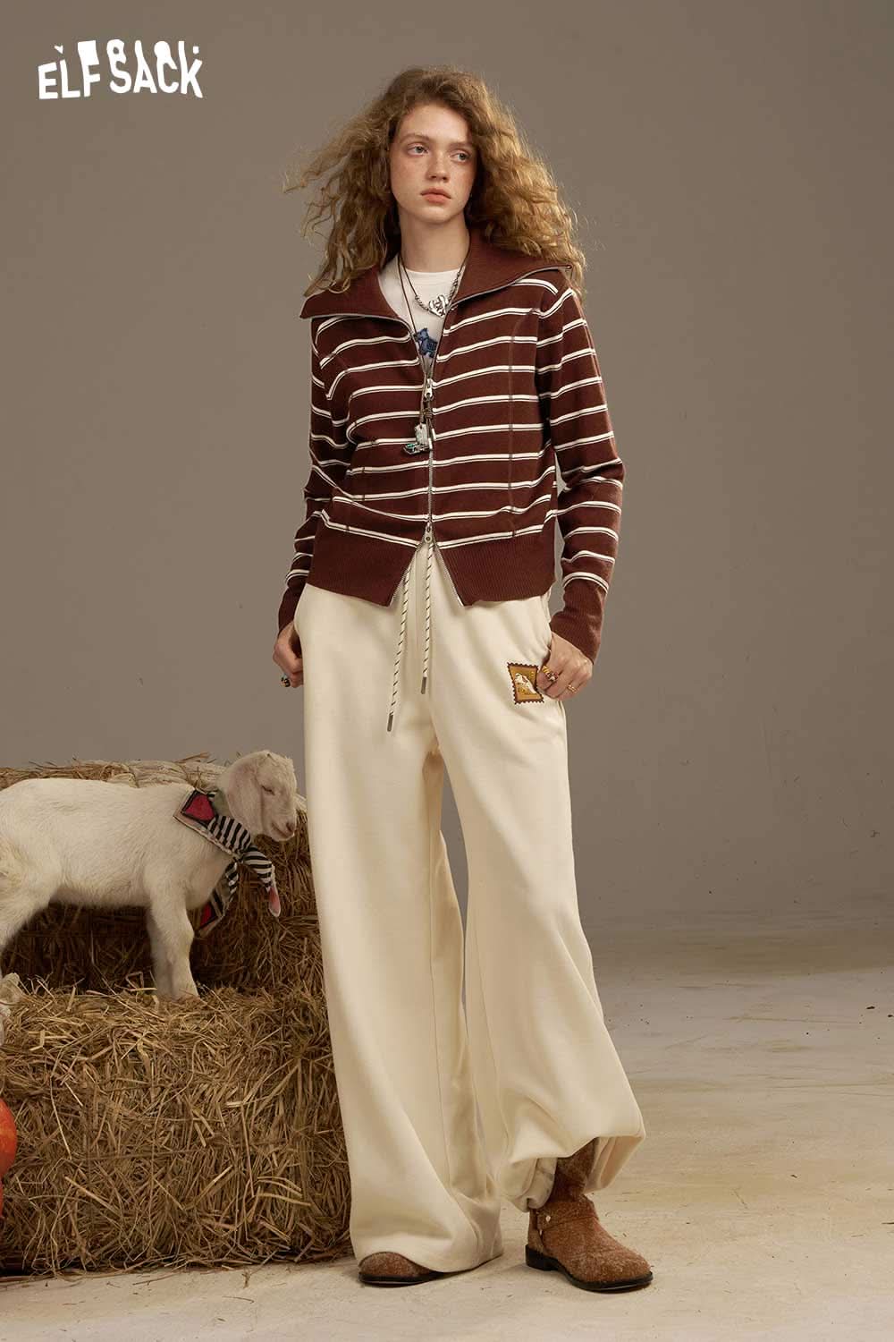 Navy collar striped knitted cardigan from ELFSACK styled with relaxed pants in a casual setting