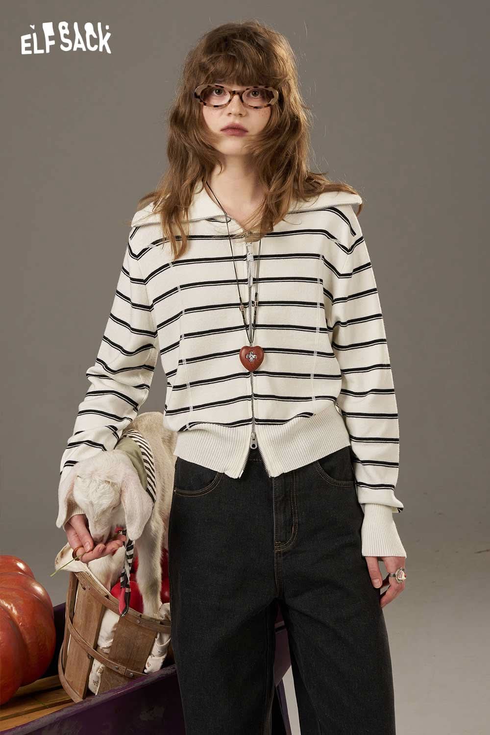 Model wearing a navy collar striped knitted cardigan, paired with dark jeans and styled accessories