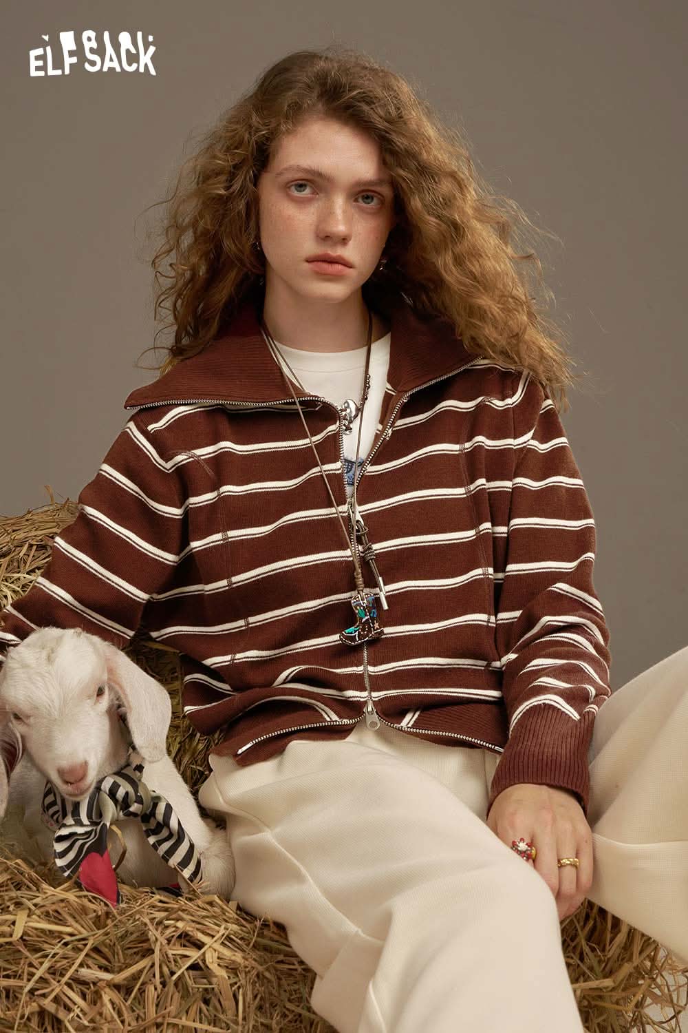 ELFSACK navy collar striped knitted cardigan styled with a model and a goat on a hay bale