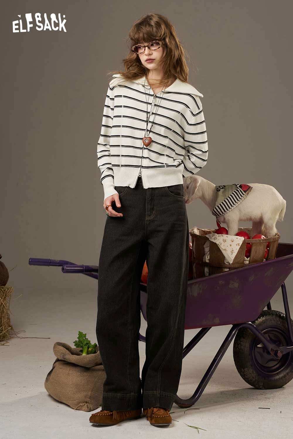 Model wearing a navy collar striped knitted cardigan paired with wide-leg black jeans