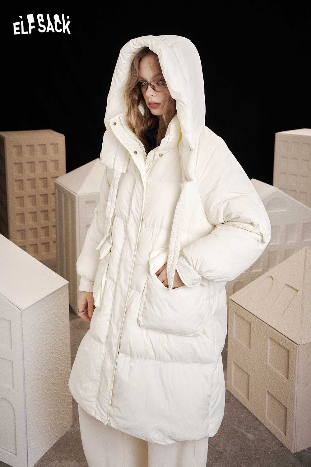 ELFSACK nylon long hooded down coat in white, featuring a cozy design and large pockets
