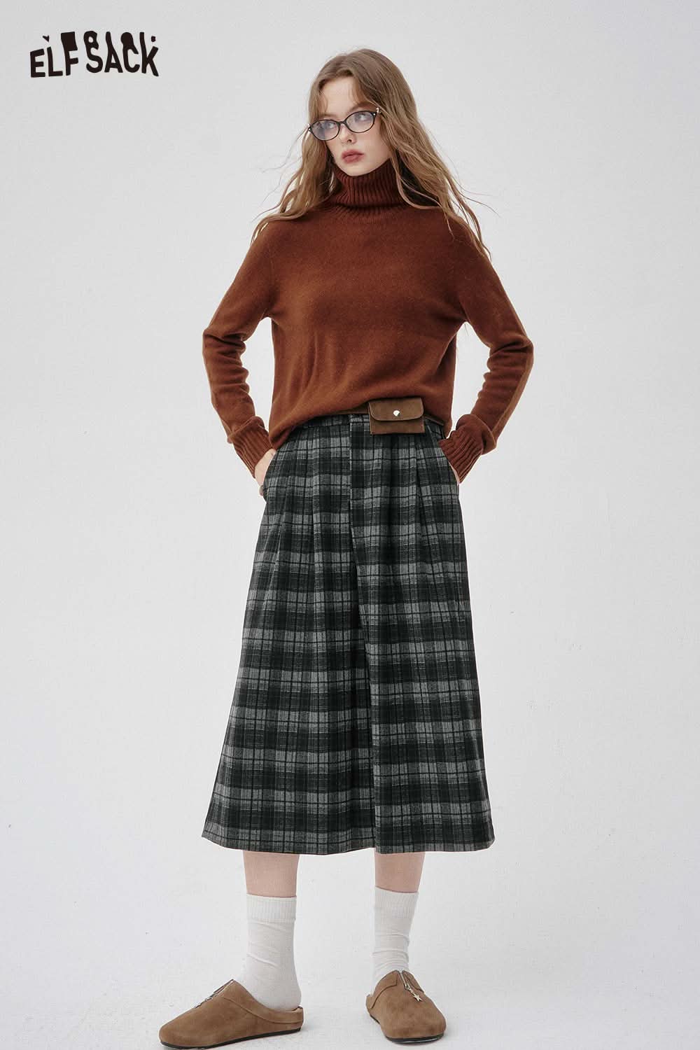 ELFSACK off-the-shoulder oversized knit sweater paired with plaid skirt and casual shoes for a stylish look