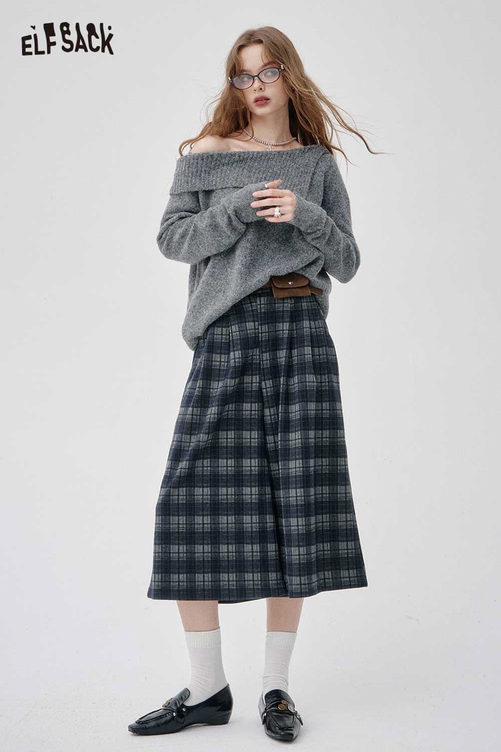 Stylish model wearing an off-the-shoulder oversized knit sweater with plaid pants from ELFSACK
