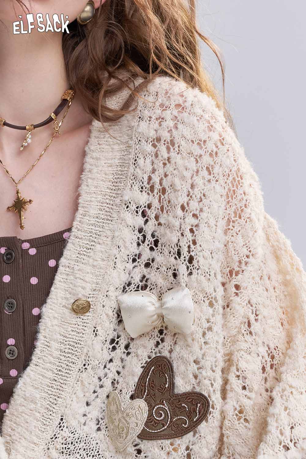 ELFSACK open knit cardigan with bows featuring a delicate lace design and heart embellishments