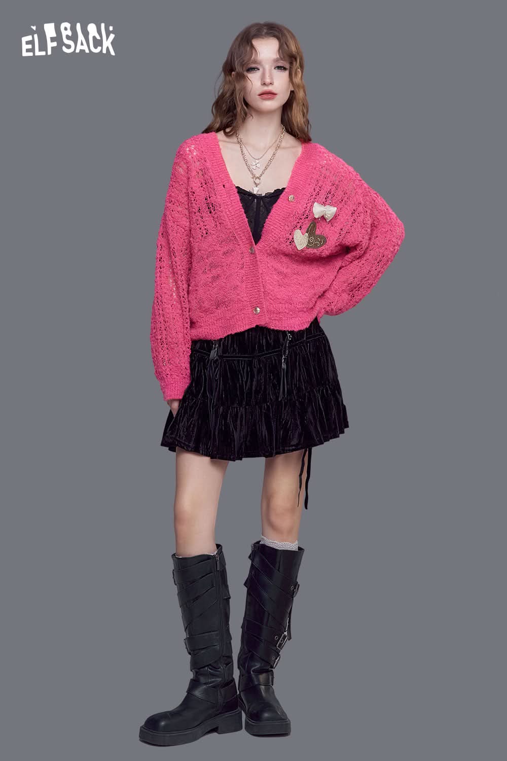 ELFSACK open knit cardigan with bows in vibrant pink, styled with a black dress for a chic look
