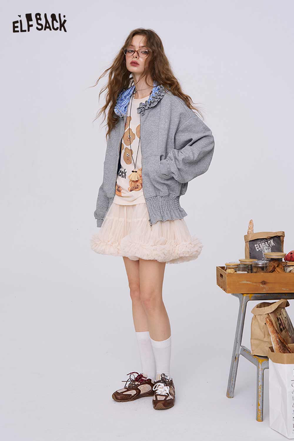 ELFSACK model wearing colorblock raglan top for women under gray zip jacket with tulle skirt