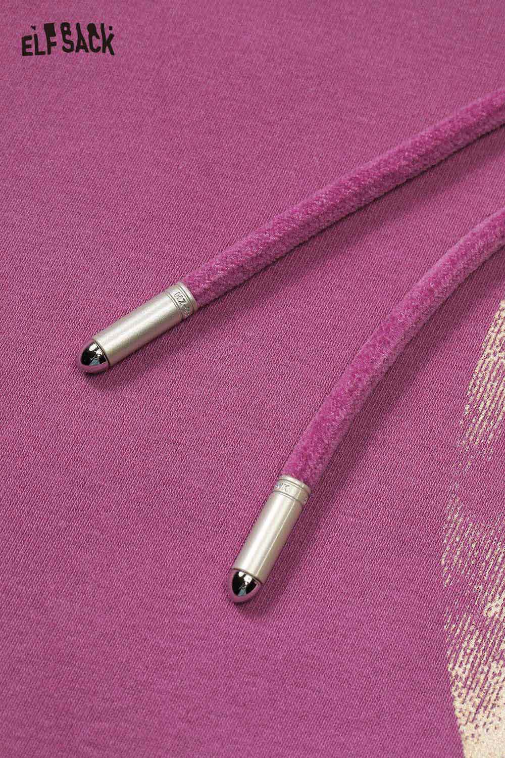 Close-up of ELFSACK oversized star graphic hoodie showcasing pink drawstrings with metallic tips