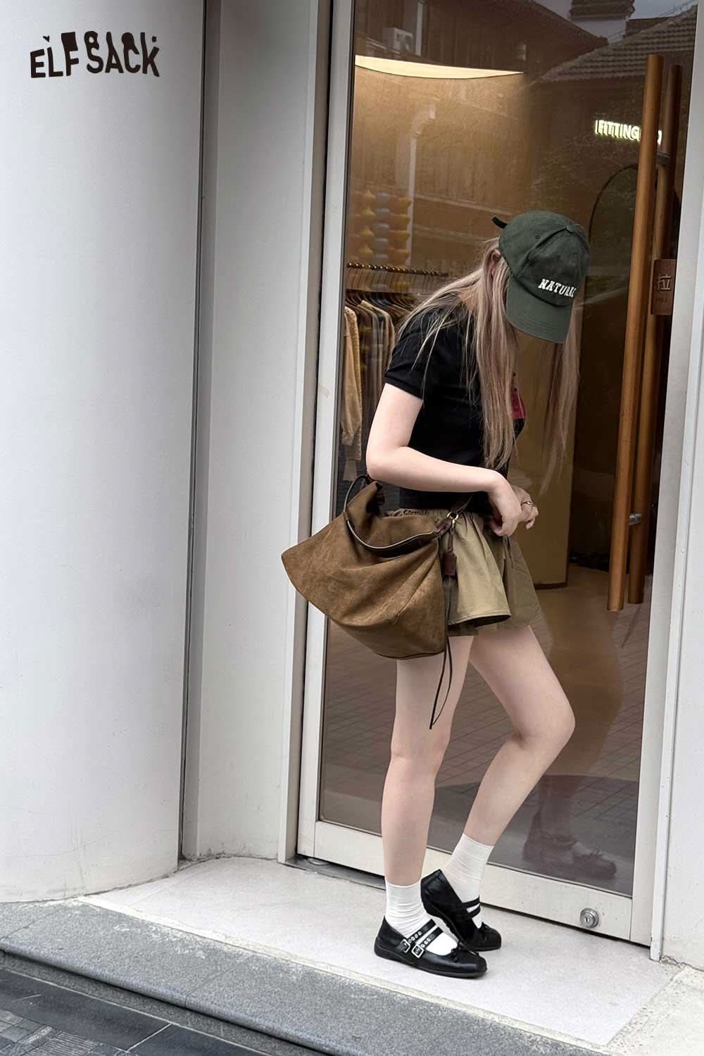 Stylish young woman with a brown oversized tote bag for women, paired with a black t-shirt and skirt