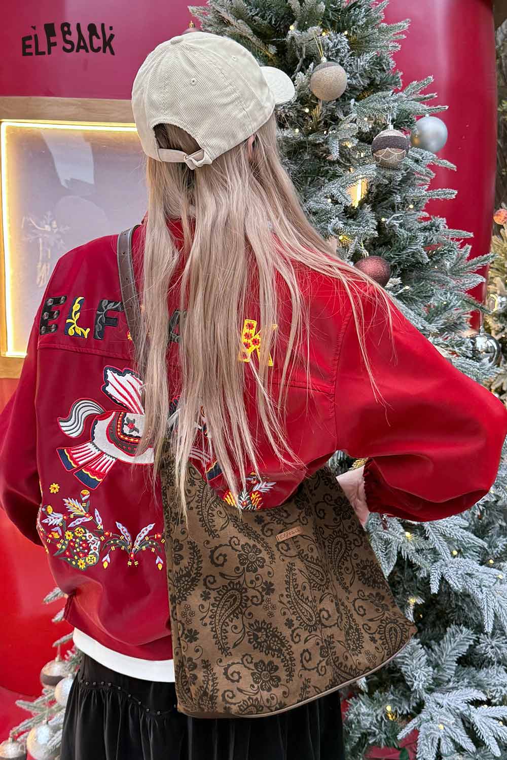 Stylish paisley crossbody bag for women worn over the shoulder with a vibrant red sweater