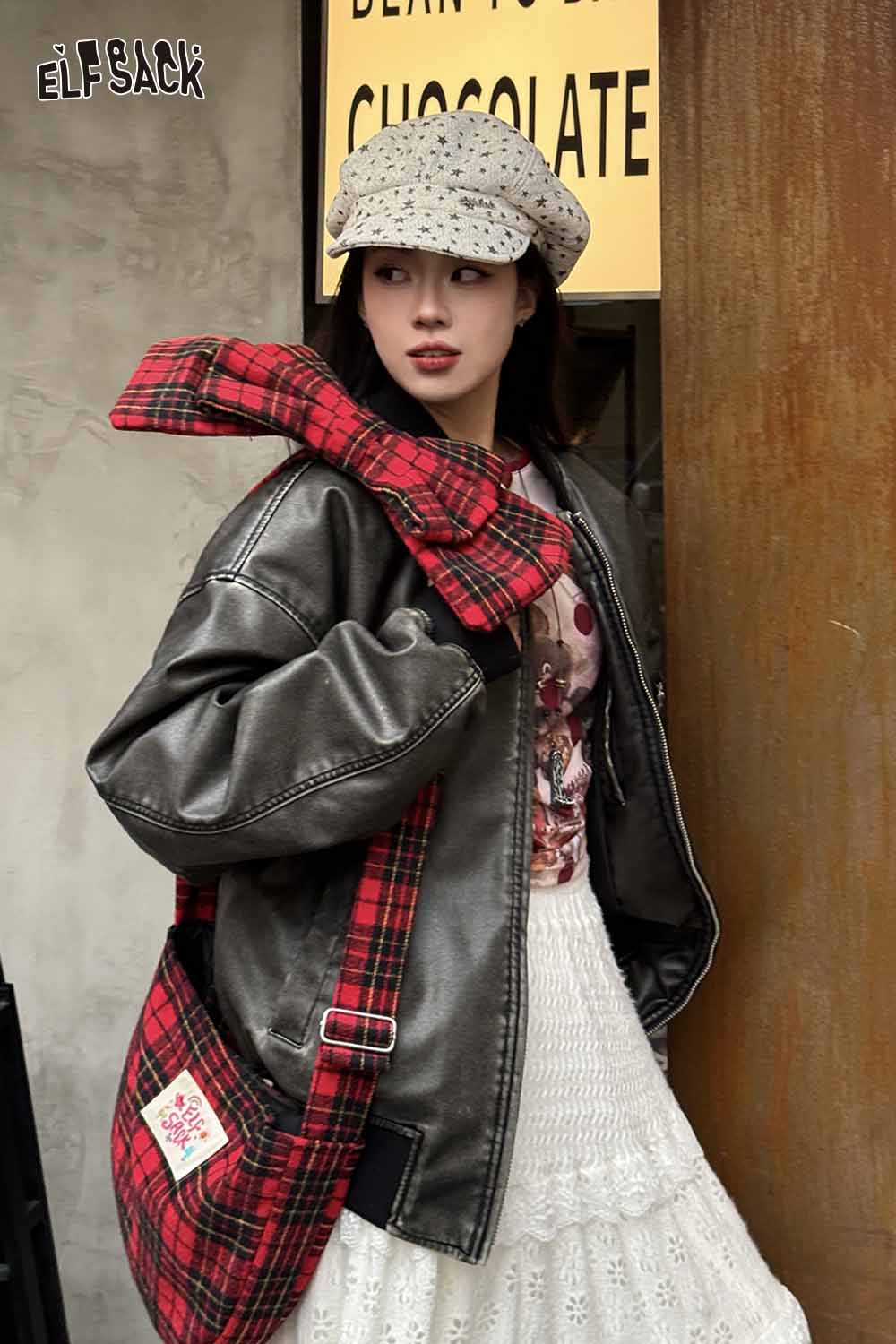 Model wearing a plaid bow crossbody bag with a stylish outfit featuring a leather jacket