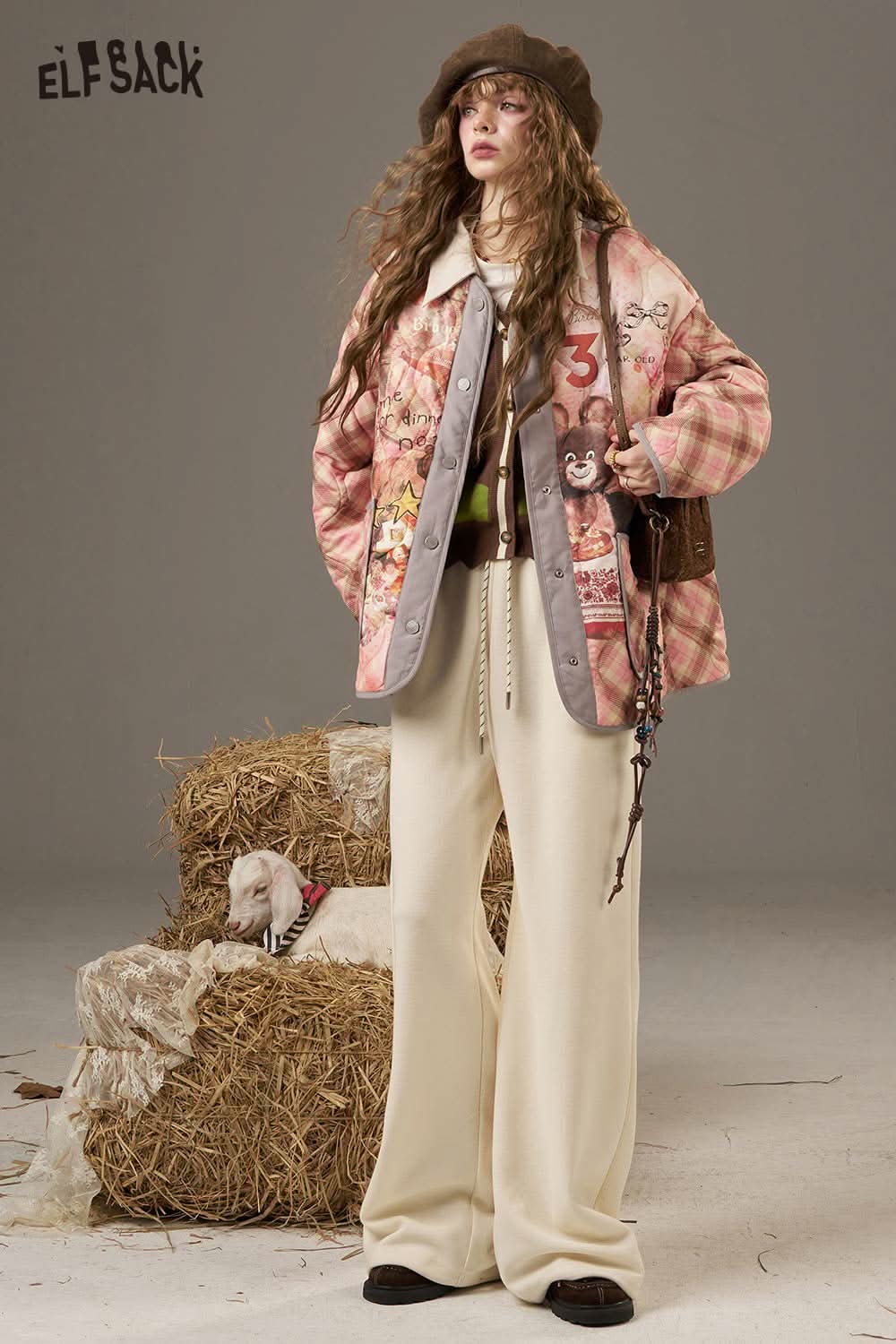 Stylish plaid knit sweater for women paired with a patterned jacket and relaxed trousers