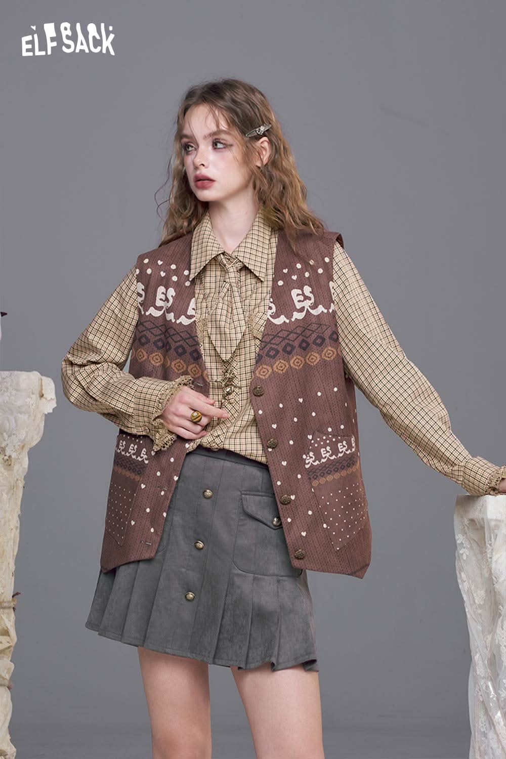 ELFSACK plaid lace accent long sleeve shirt paired with a patterned vest and a grey skirt