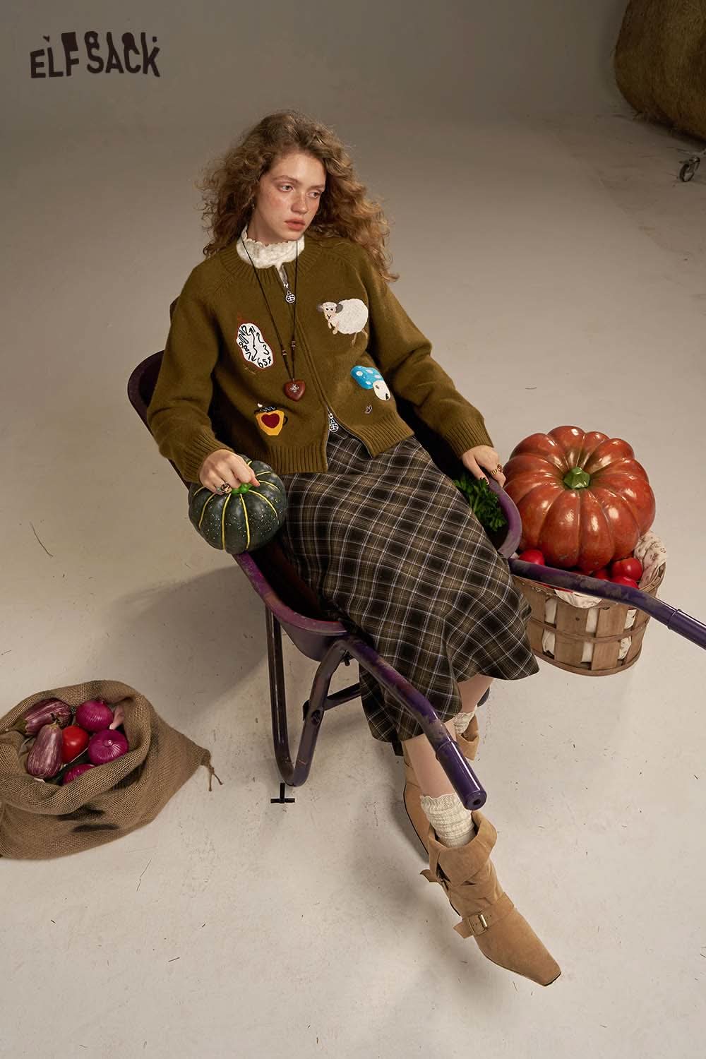 ELFSACK plaid straight long skirt styled with a cozy green cardigan and fall vegetables for a seasonal look