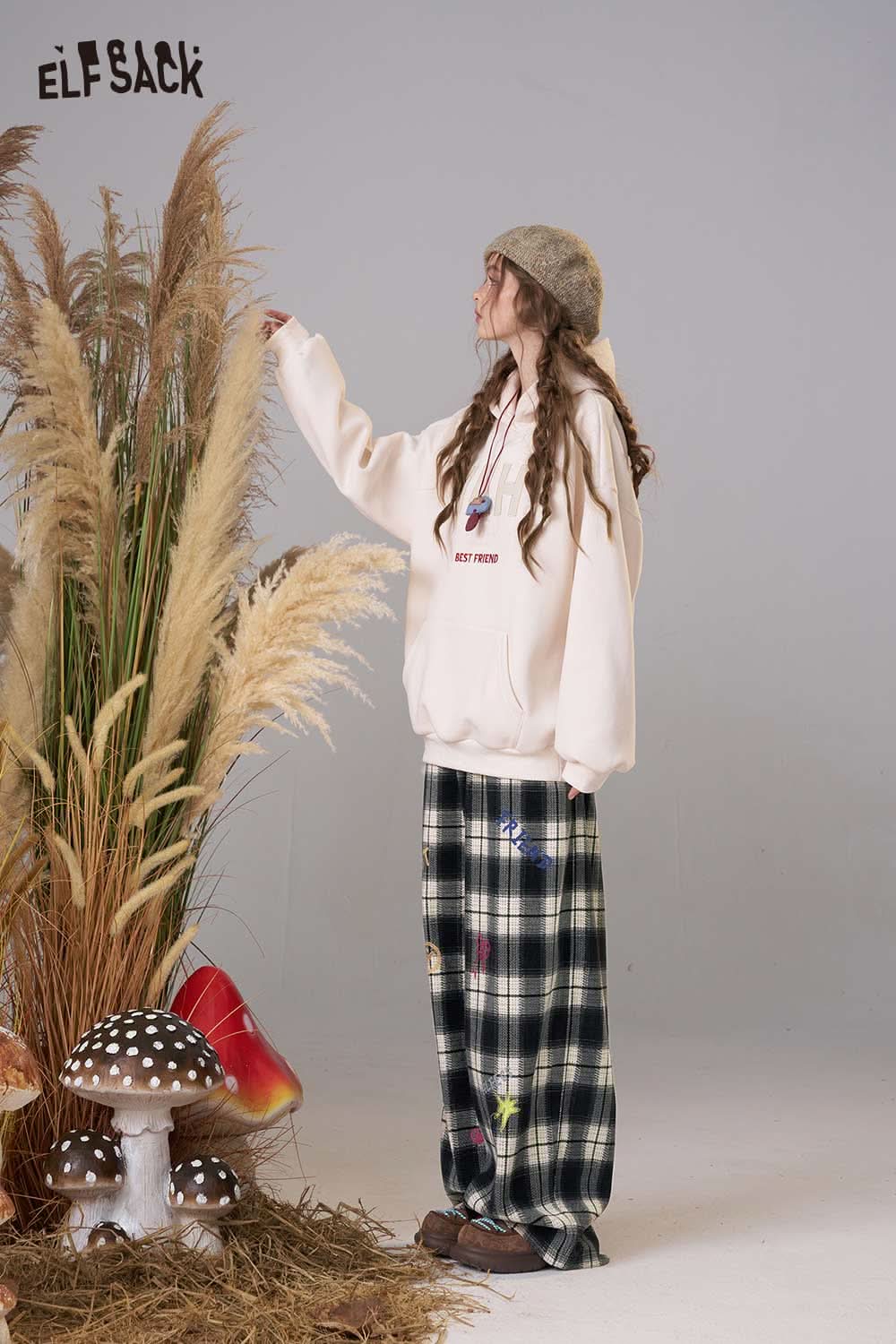 ELFSACK plaid wide leg pants for women styled with a cozy hoodie and set against a whimsical backdrop